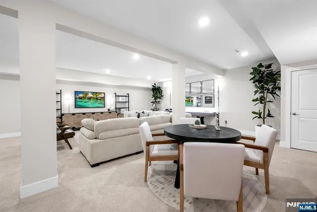 a living room with furniture a wooden floor and a large window