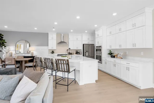 a kitchen with stainless steel appliances kitchen island granite countertop a sink and cabinets