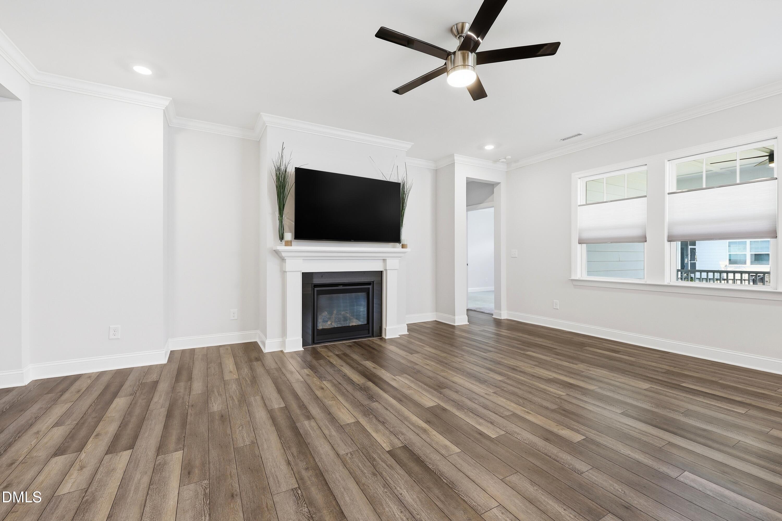 289 English Violet Lane Raleigh, NC 27610 - Photo 16 of 40 a view of empty room with wooden floor and fireplace
