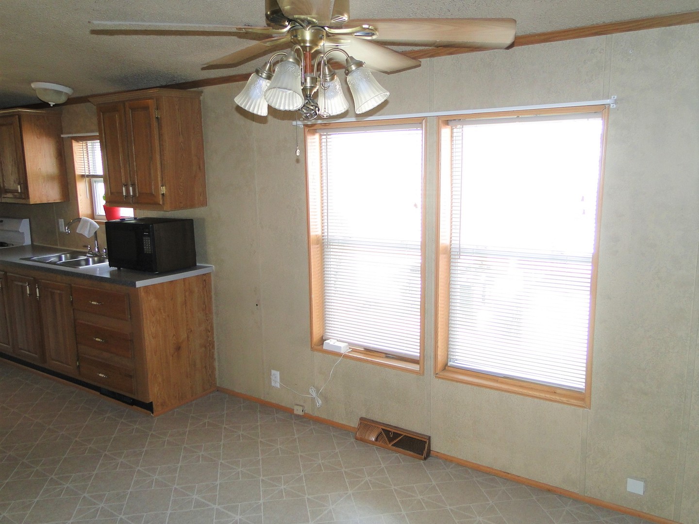 26 Maple Street Minooka, IL 60447 - Photo 5 of 13 a kitchen with stainless steel appliances a window and cabinets