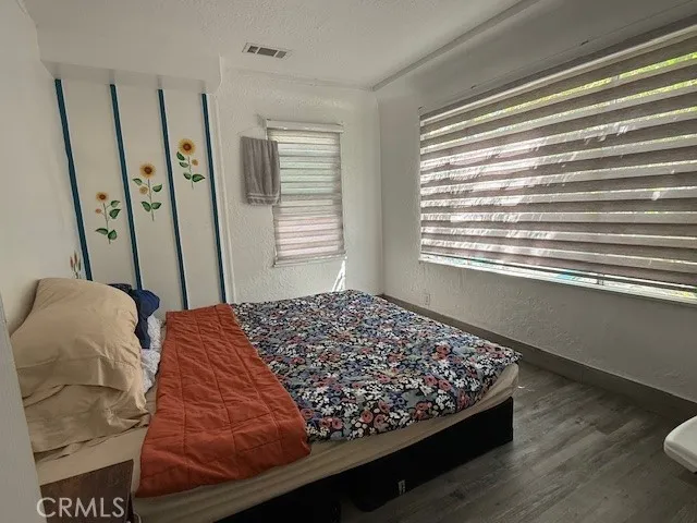 a bed sitting in a bedroom next to a window