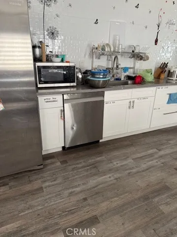 a kitchen with stainless steel appliances granite countertop a sink and cabinets