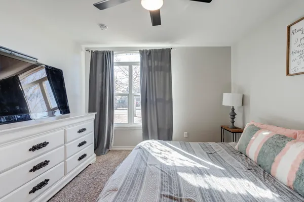 a bedroom with a large bed and a dresser