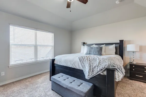 a bedroom with a bed and window
