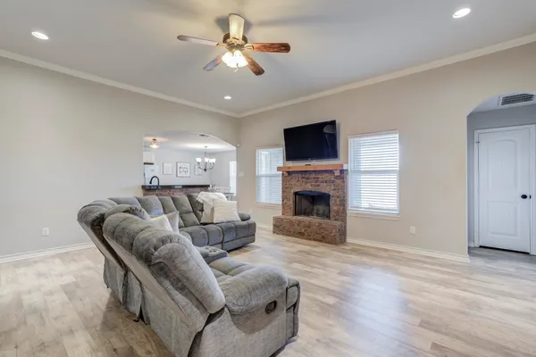 a living room with furniture a fireplace and a flat screen tv