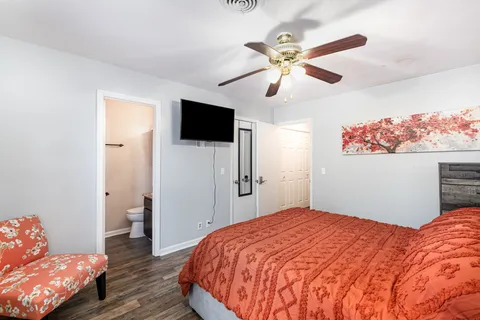 a bedroom with a bed and a flat screen tv