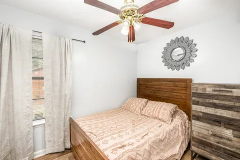 a bedroom with a bed and a chandelier