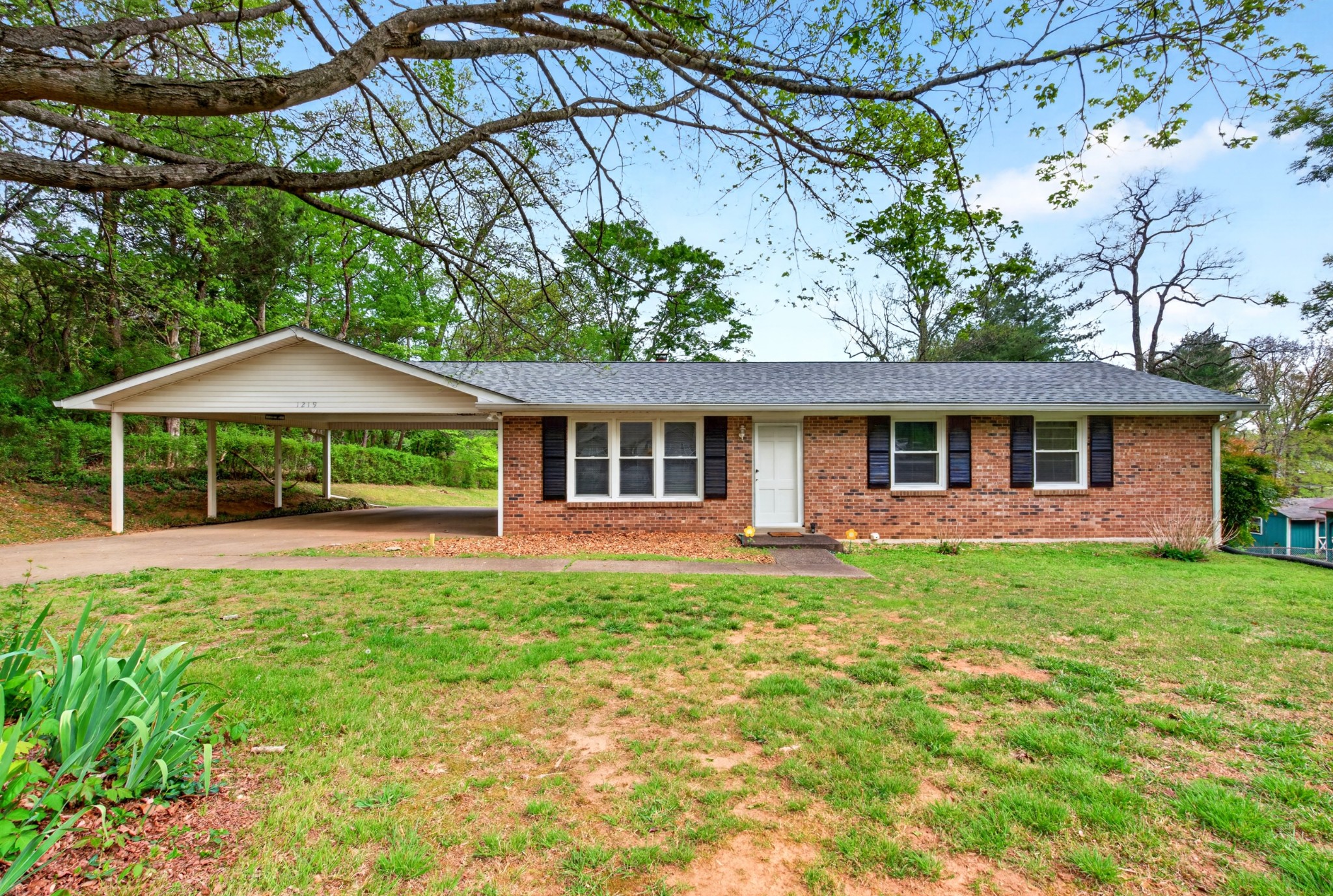 a front view of a house with a garden and porch