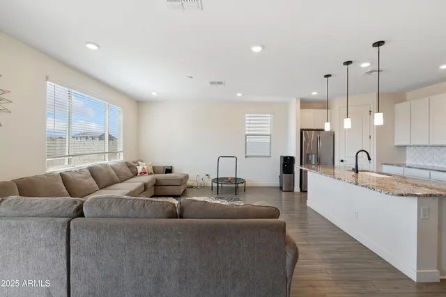a view of a hallway with wooden floor and entryway