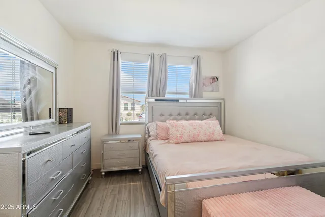 a living room with furniture a wooden floor and a view of kitchen