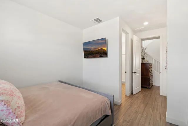 a bedroom with a large bed and a window