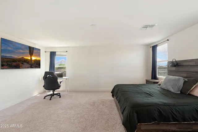 a bedroom with a bed and a chair