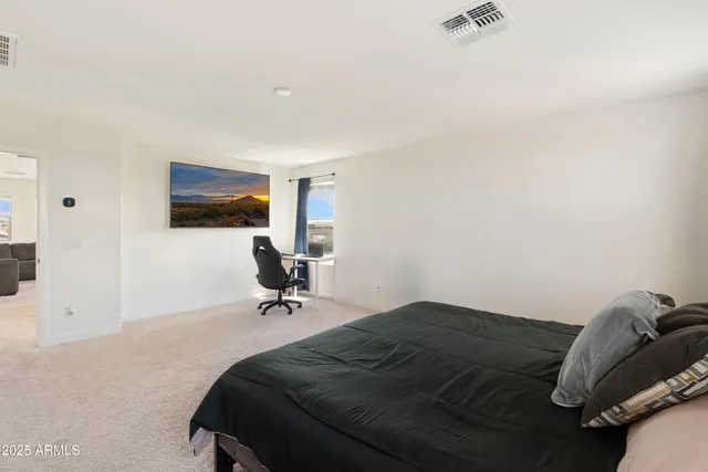 a bedroom with a bed window and television
