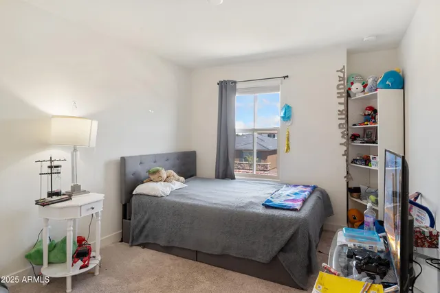a view of walk in closet with clothes