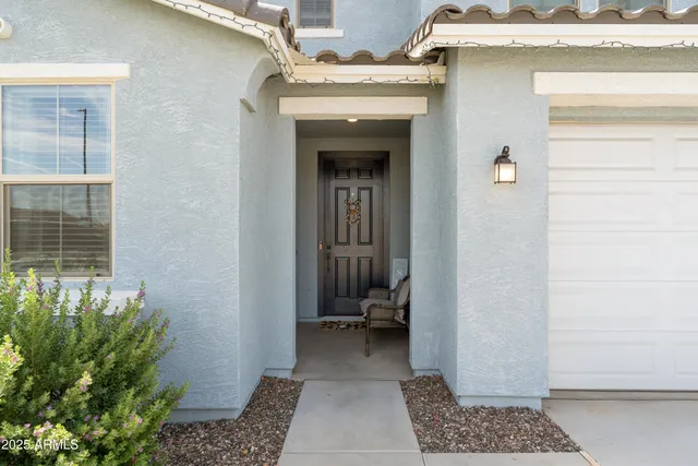 a front view of a house with a garden