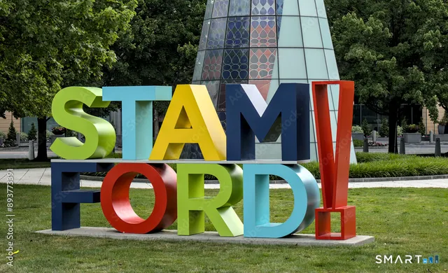 a view of a city street lined with buildings and trees