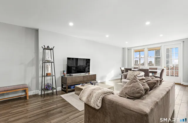 a living room with furniture and a flat screen tv