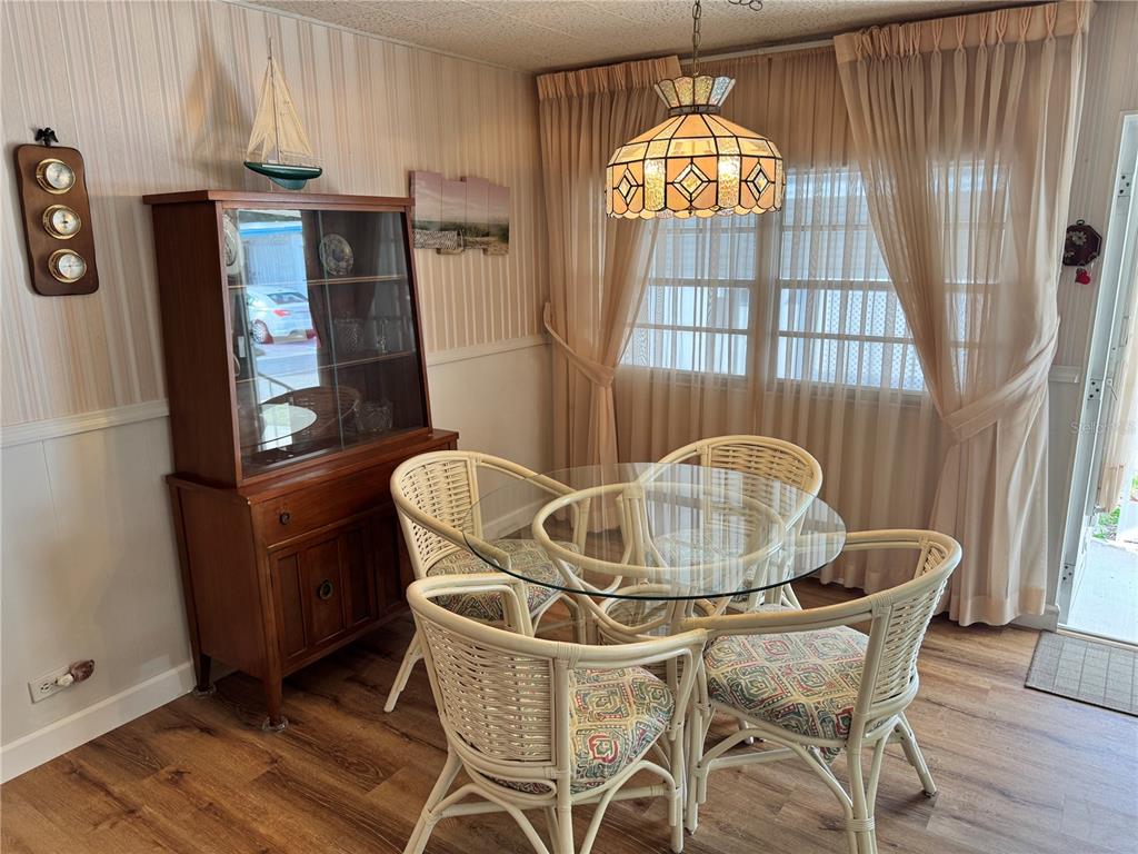 2331 Belleair Road, Unit 804 Clearwater, FL 33764 - Photo 11 of 37 a dining room with furniture a chandelier and wooden floor