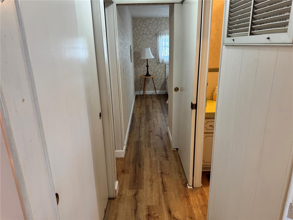 2331 Belleair Road, Unit 804 Clearwater, FL 33764 - Photo 14 of 37 a view of a hallway with wooden floor and a bathroom
