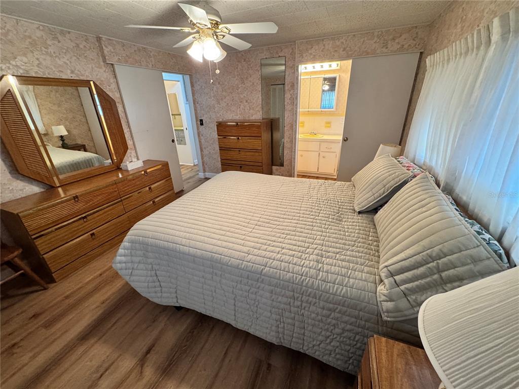 2331 Belleair Road, Unit 804 Clearwater, FL 33764 - Photo 16 of 37 a bedroom with a bed and wooden floor