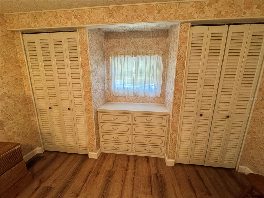 2331 Belleair Road, Unit 804 Clearwater, FL 33764 - Photo 17 of 37 an empty room with wooden floor and cabinet