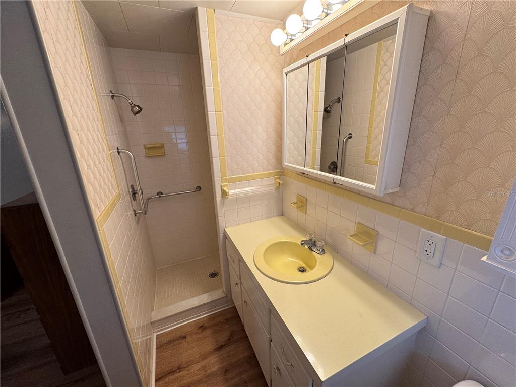 2331 Belleair Road, Unit 804 Clearwater, FL 33764 - Photo 19 of 37 a bathroom with a sink a washer and dryer