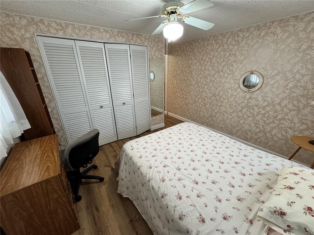 2331 Belleair Road, Unit 804 Clearwater, FL 33764 - Photo 21 of 37 a bedroom with a bed and a chandelier