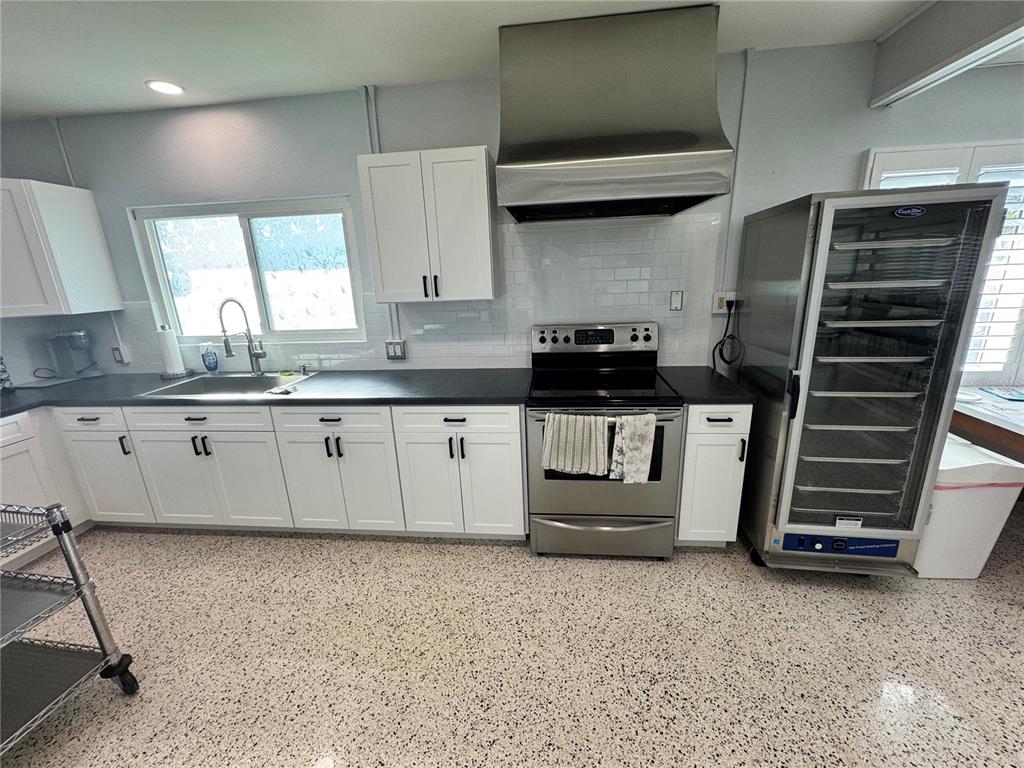 2331 Belleair Road, Unit 804 Clearwater, FL 33764 - Photo 35 of 37 a kitchen with granite countertop a stove a sink and a refrigerator
