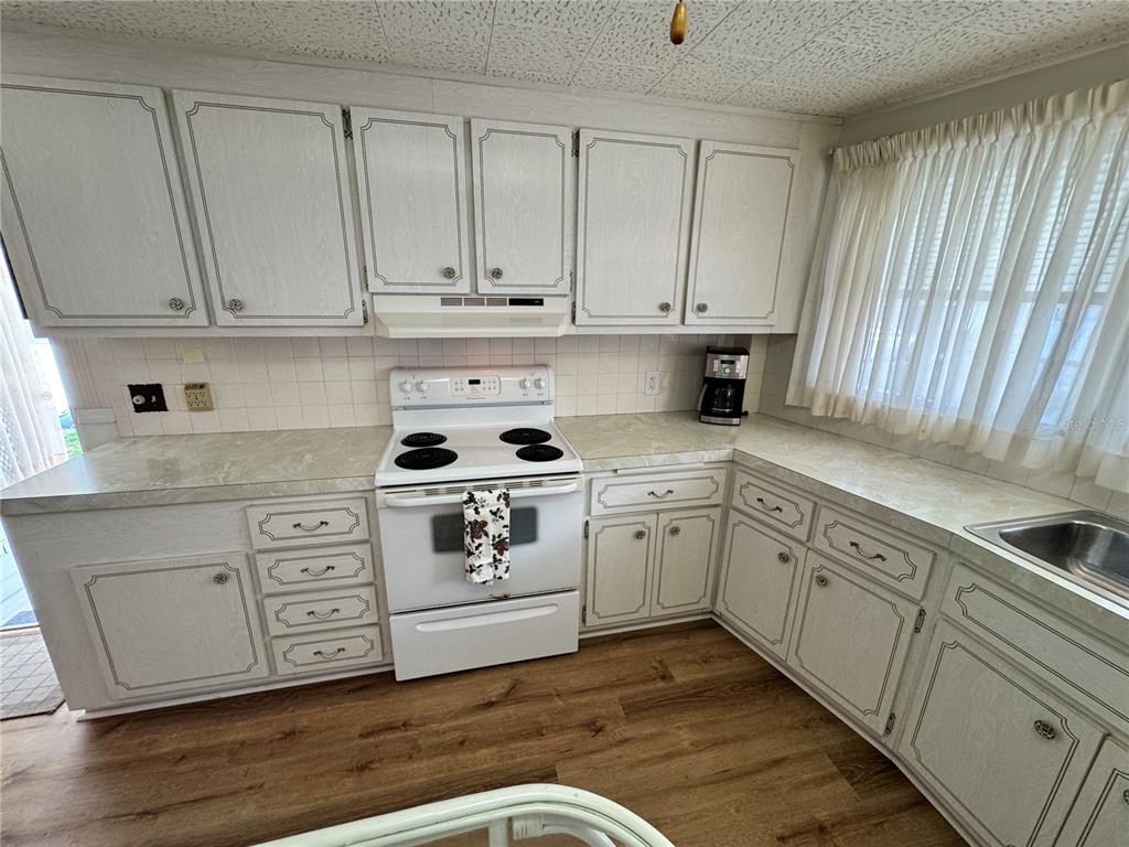 2331 Belleair Road, Unit 804 Clearwater, FL 33764 - Photo 6 of 37 a kitchen with white cabinets and white appliances