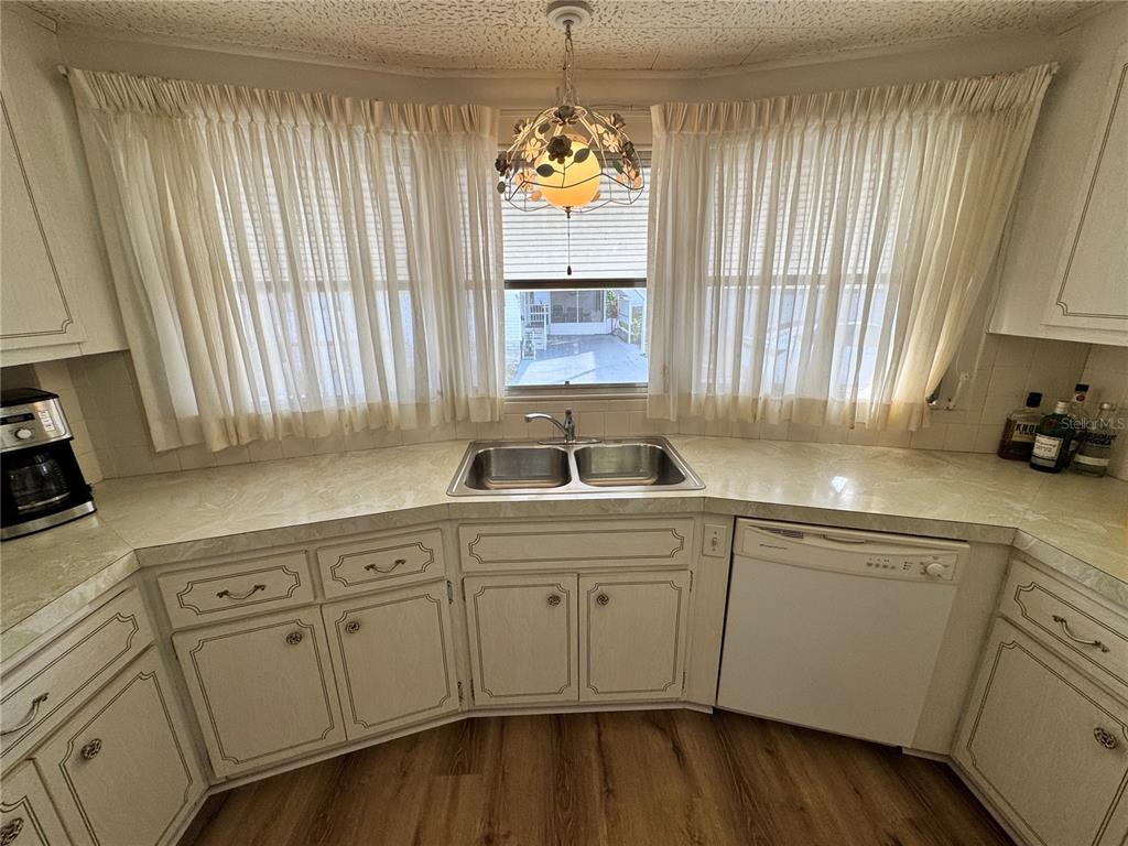 2331 Belleair Road, Unit 804 Clearwater, FL 33764 - Photo 7 of 37 a kitchen with white cabinets and a sink