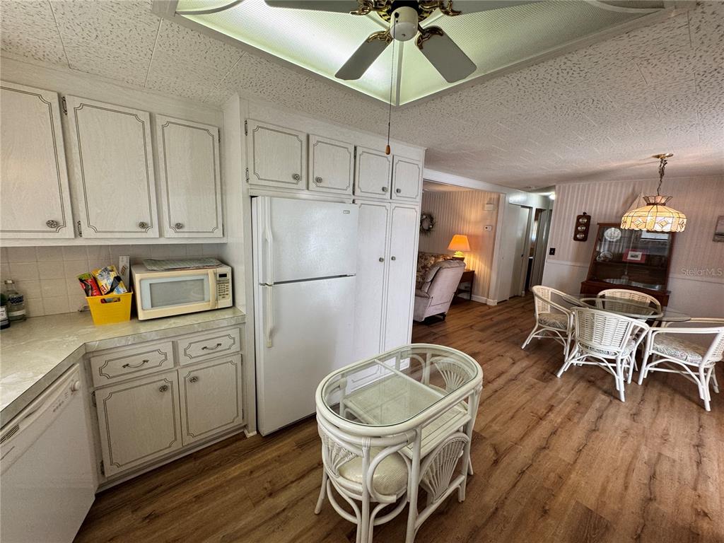 2331 Belleair Road, Unit 804 Clearwater, FL 33764 - Photo 8 of 37 a kitchen with stainless steel appliances a dining table chairs refrigerator and sink