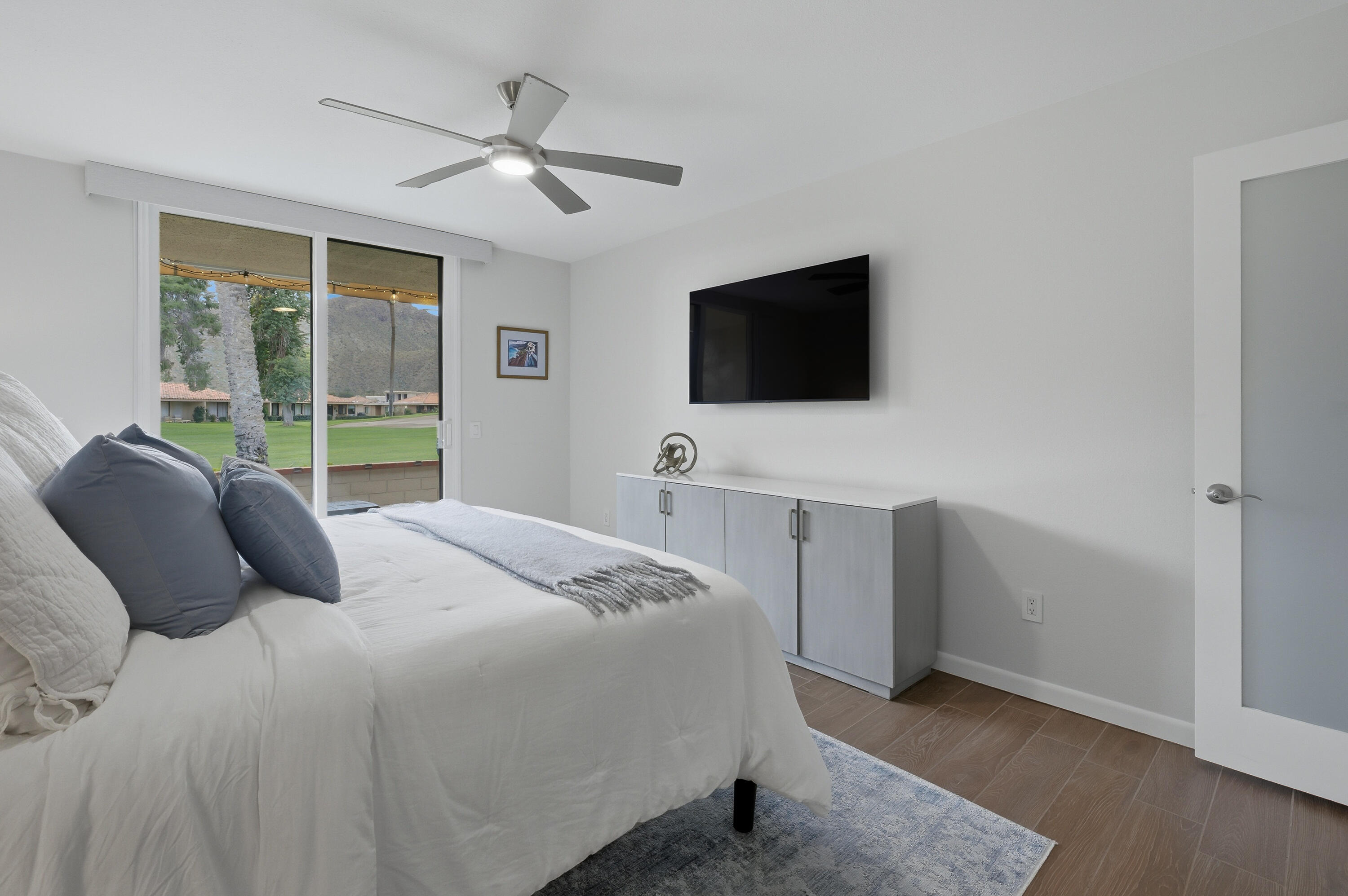 24 Palma Drive Rancho Mirage, CA 92270 - Photo 22 of 40 a bedroom with a bed and a flat screen tv