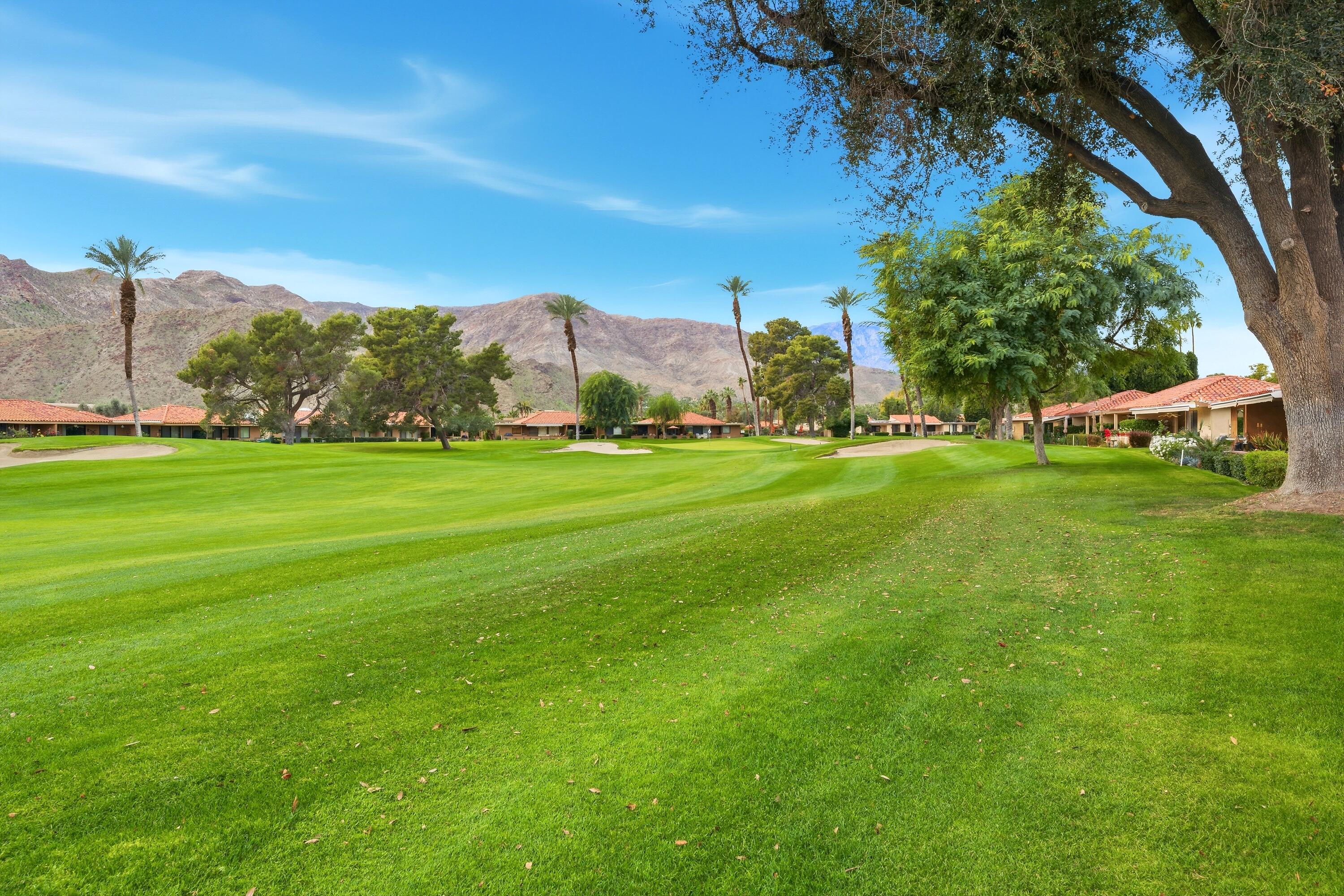 24 Palma Drive Rancho Mirage, CA 92270 - Photo 27 of 40 a view of a grassy field with an trees