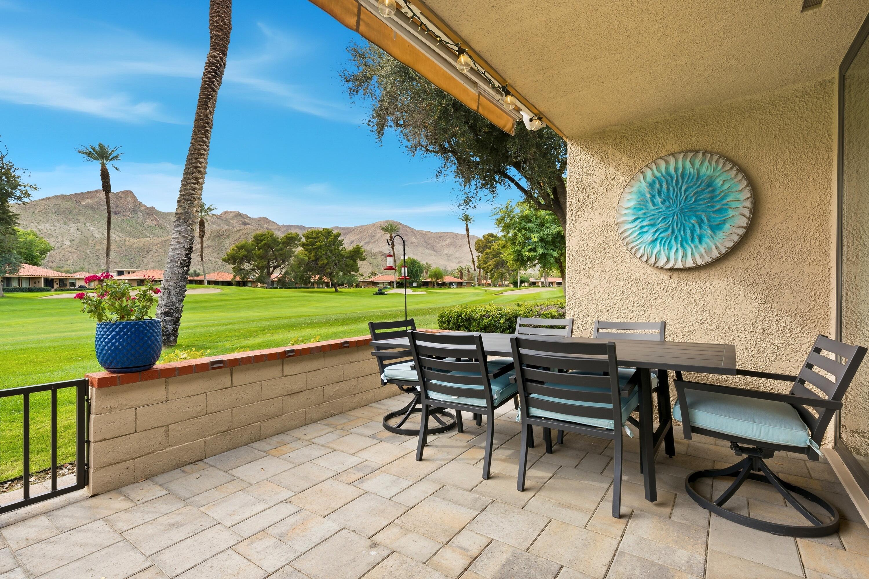24 Palma Drive Rancho Mirage, CA 92270 - Photo 28 of 40 a view of a chairs and table in patio with a yard