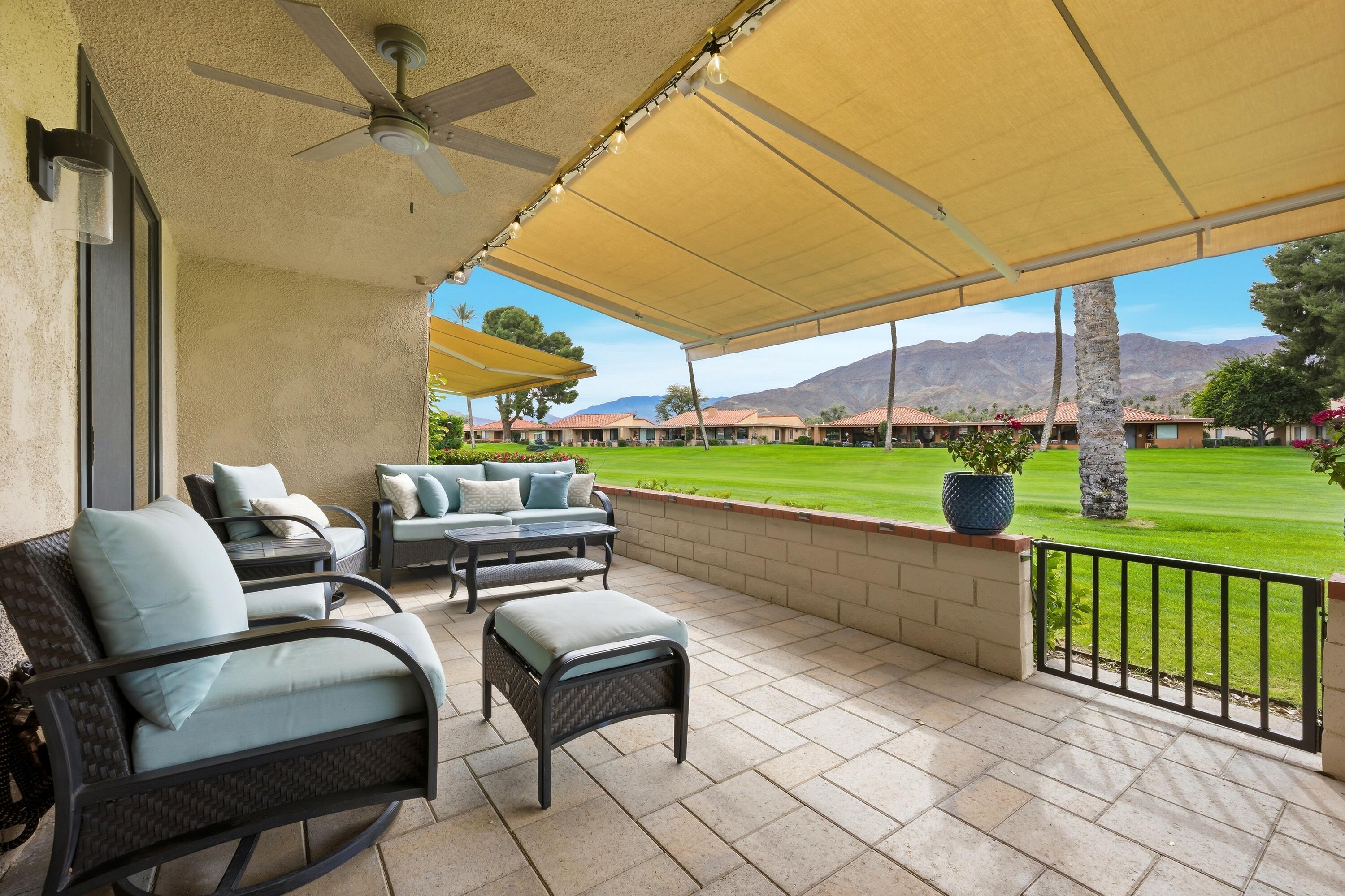 24 Palma Drive Rancho Mirage, CA 92270 - Photo 32 of 40 a view of a patio with a table and chairs under an umbrella