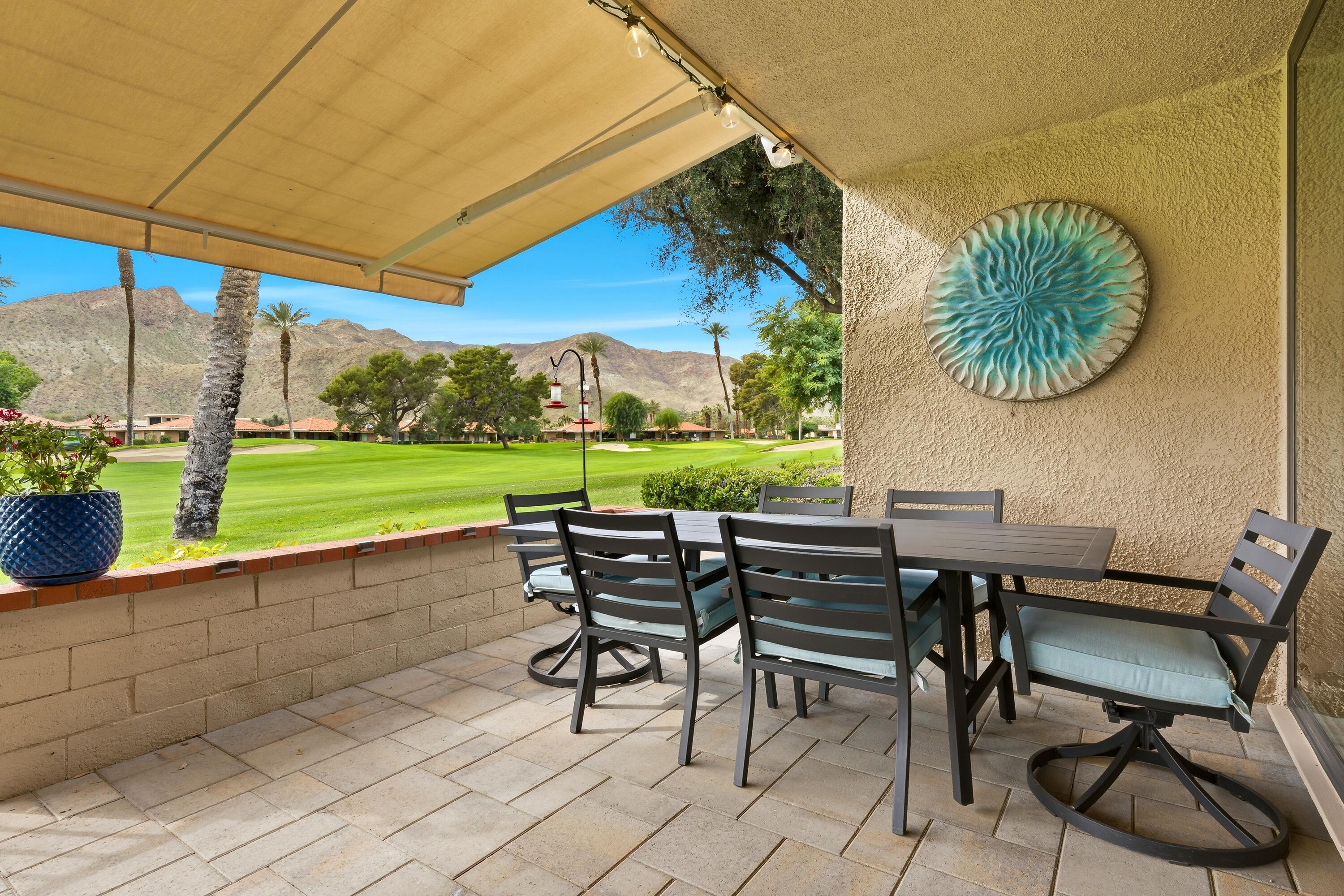 24 Palma Drive Rancho Mirage, CA 92270 - Photo 33 of 40 a view of a chairs and table in patio with a yard