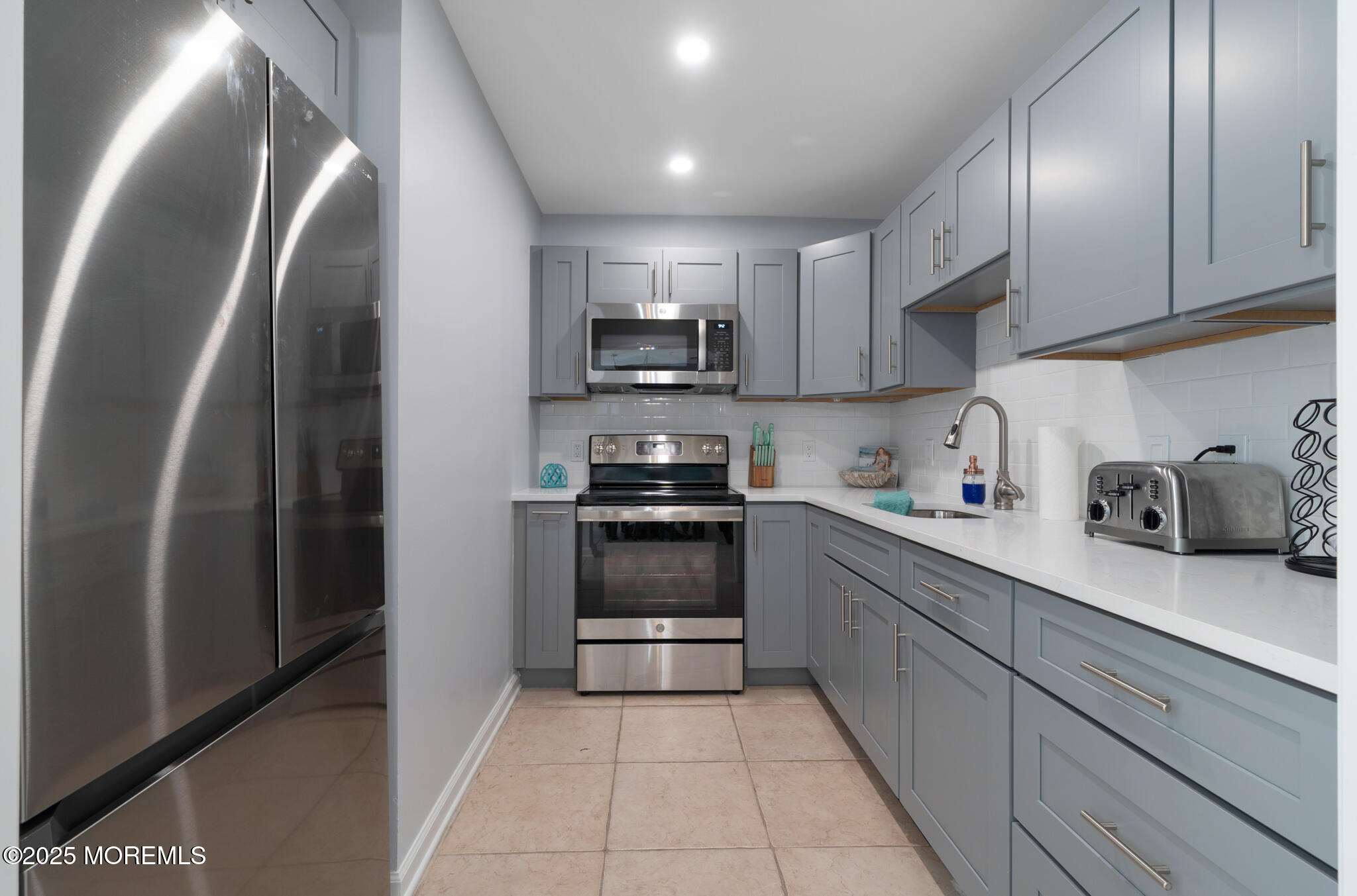 33 Sumner Avenue, Unit 5B RENTAL Seaside Heights, NJ 08751 - Photo 15 of 37 a kitchen with stainless steel appliances granite countertop a refrigerator and a stove top oven