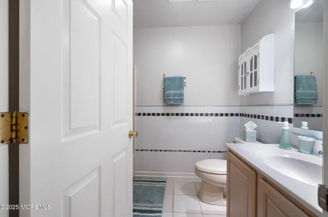 a bathroom with a toilet a sink and a window