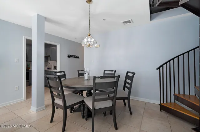 a view of a dining room with furniture and chandelier