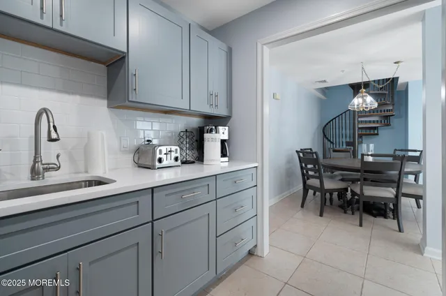 a kitchen with cabinets and chairs in it