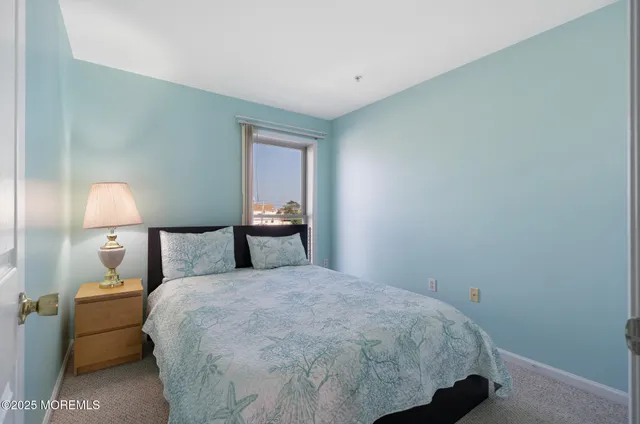 a bedroom with a bed and a lamp