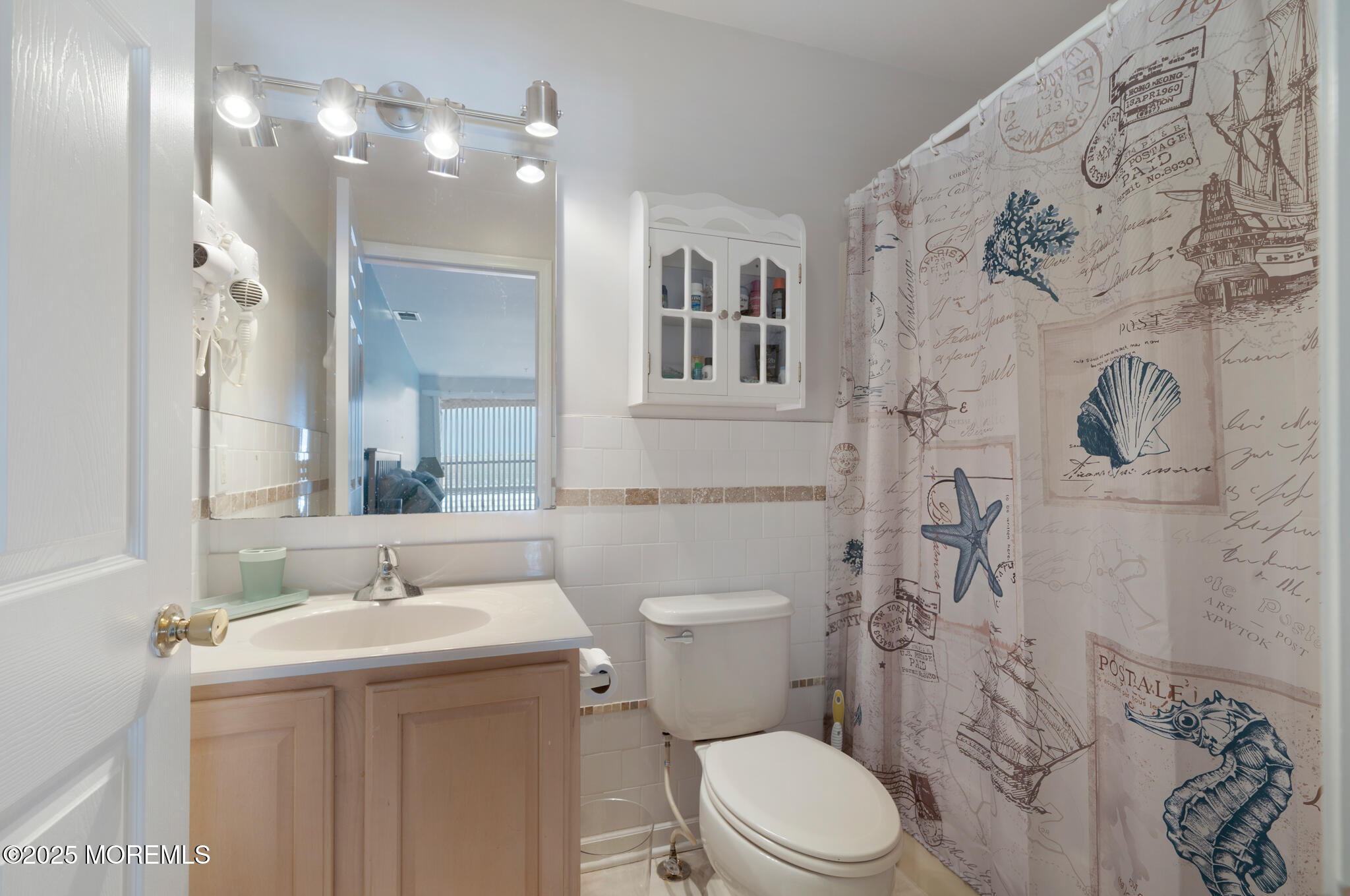 33 Sumner Avenue, Unit 5B RENTAL Seaside Heights, NJ 08751 - Photo 25 of 37 a bathroom with a sink and mirror with toilet