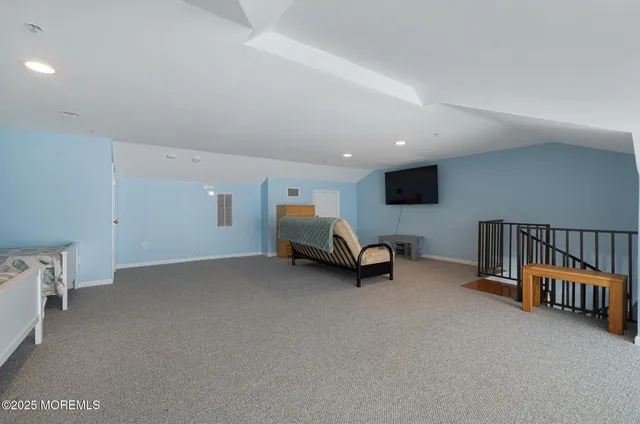 a view of a livingroom with furniture and a flat screen tv