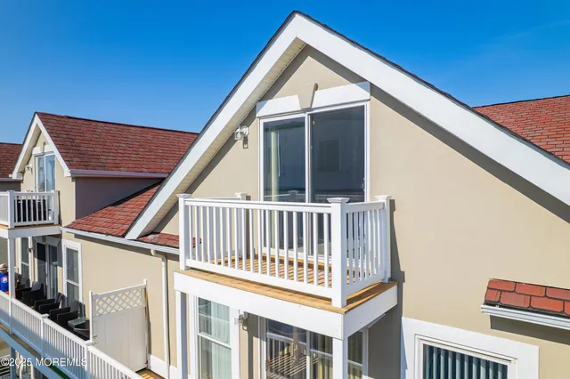 a view of balcony with small white wall and stairs