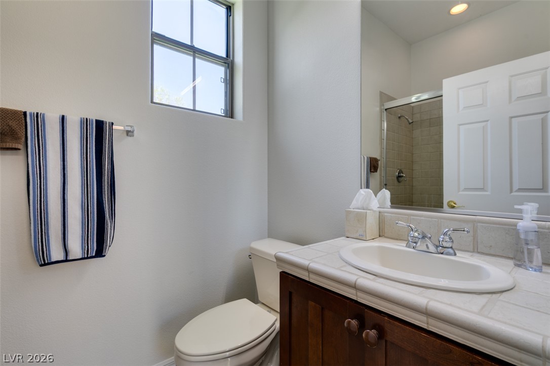 8 Kennesaw Road Henderson, NV 89052 - Photo 38 of 44 A well-appointed bathroom offers a convenient vanity, toilet, and shower.
