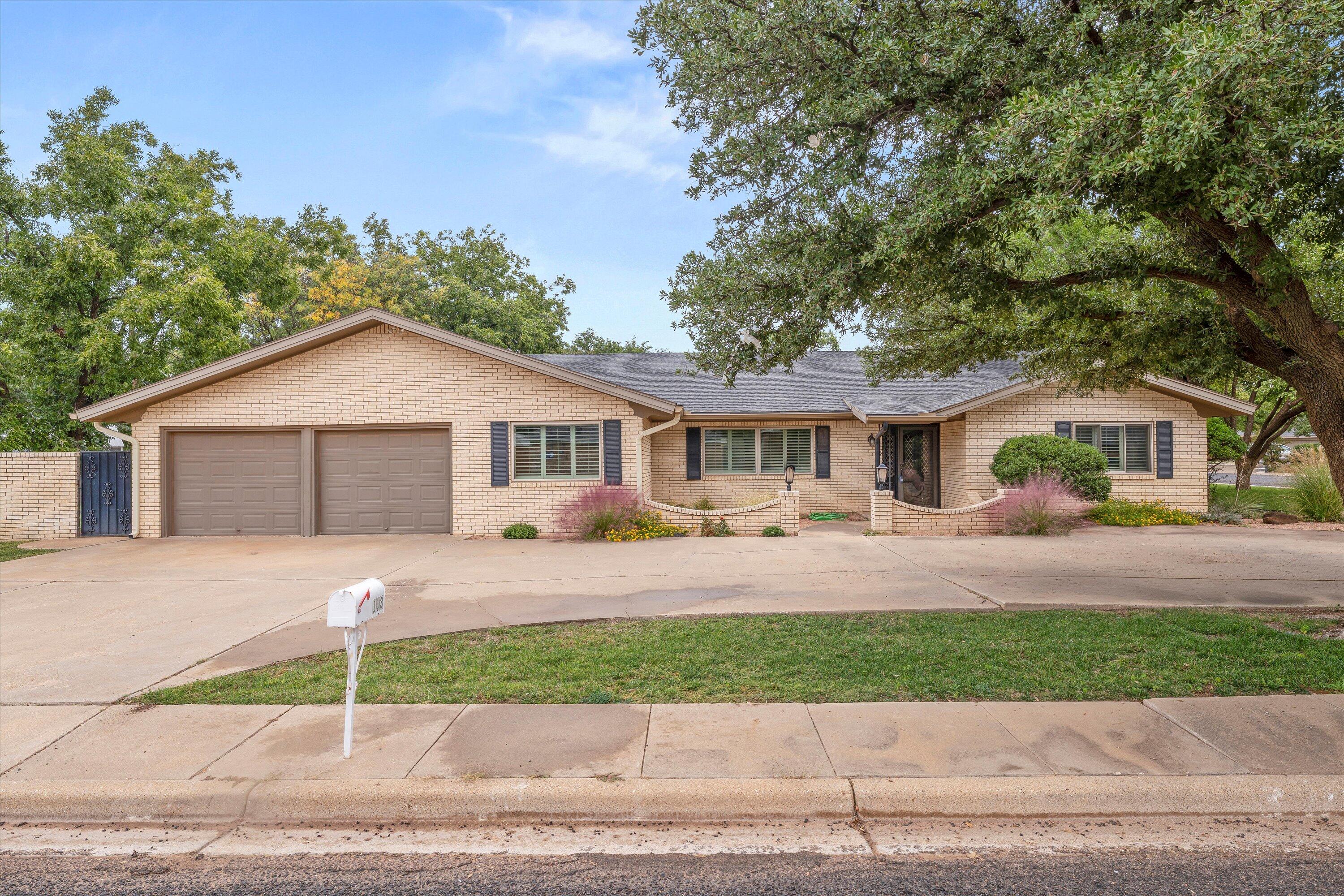 103 Baylor Lane Levelland, TX 79336 - Photo 3 of 27 a front view of a house with a yard and garage