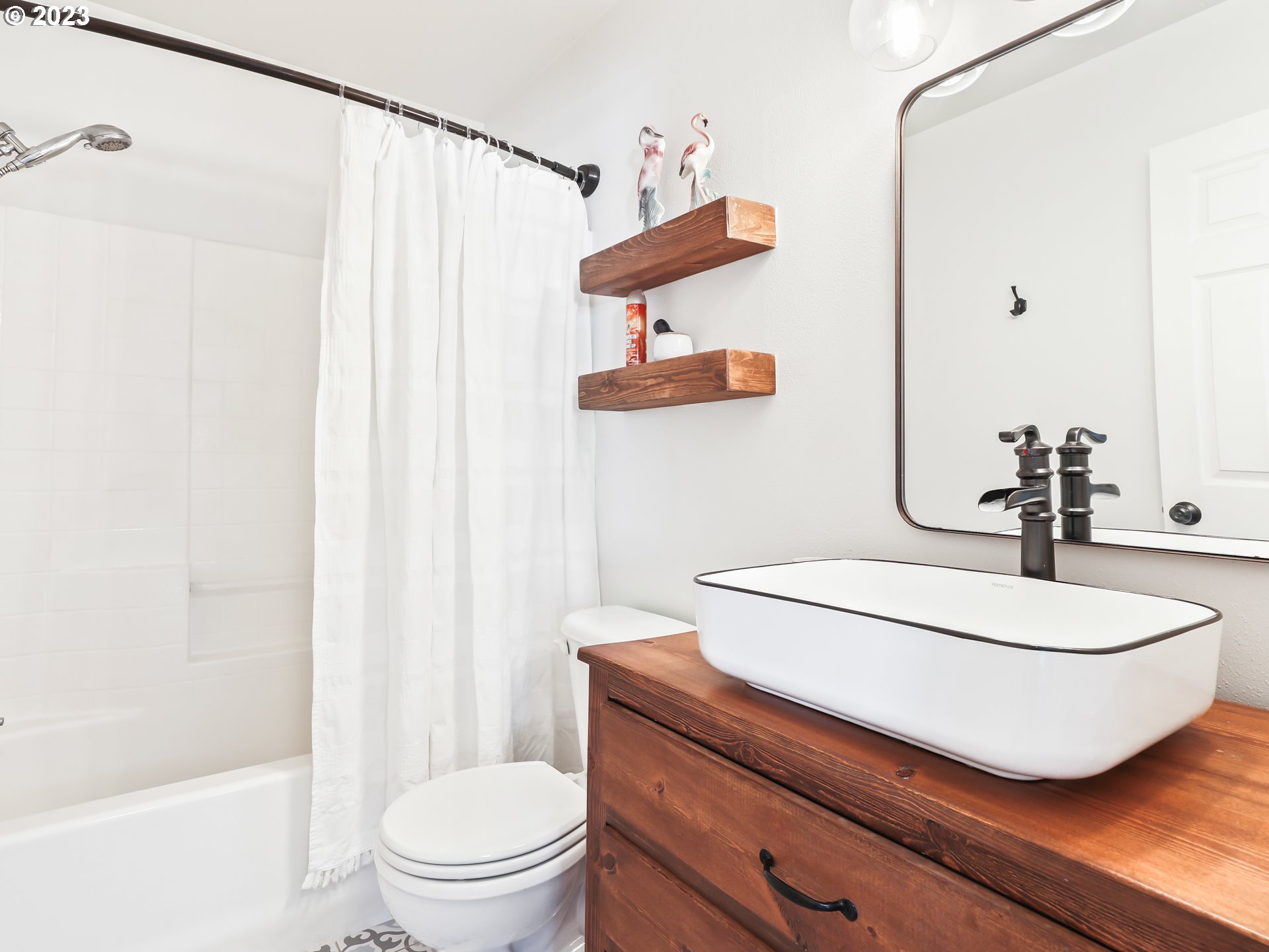 15820 Northeast Beech Street Portland, OR 97230 - Photo 19 of 28 a bathroom with a sink a toilet and shower curtain