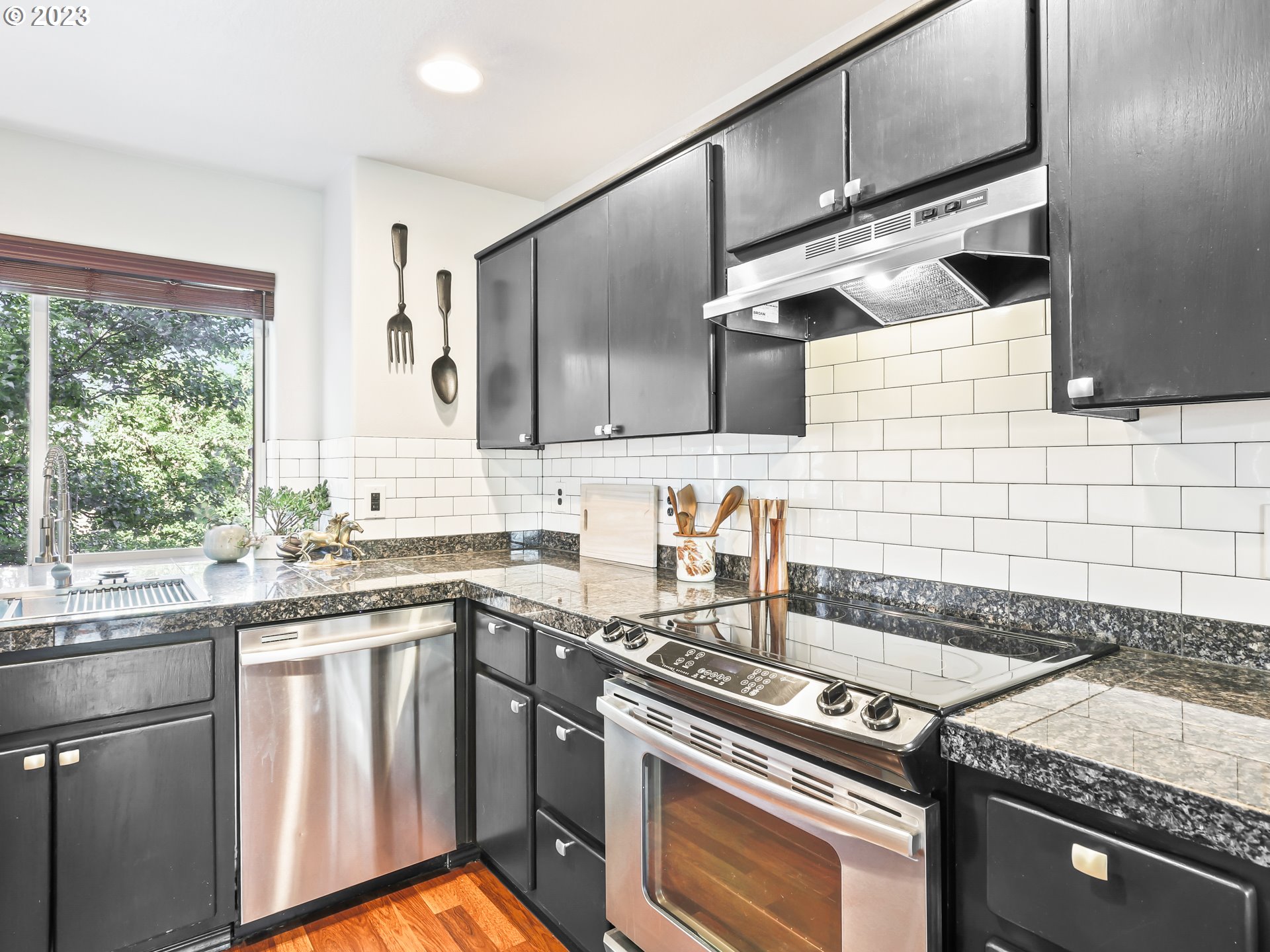 15820 Northeast Beech Street Portland, OR 97230 - Photo 8 of 28 a kitchen with stainless steel appliances granite countertop a sink stove and cabinets