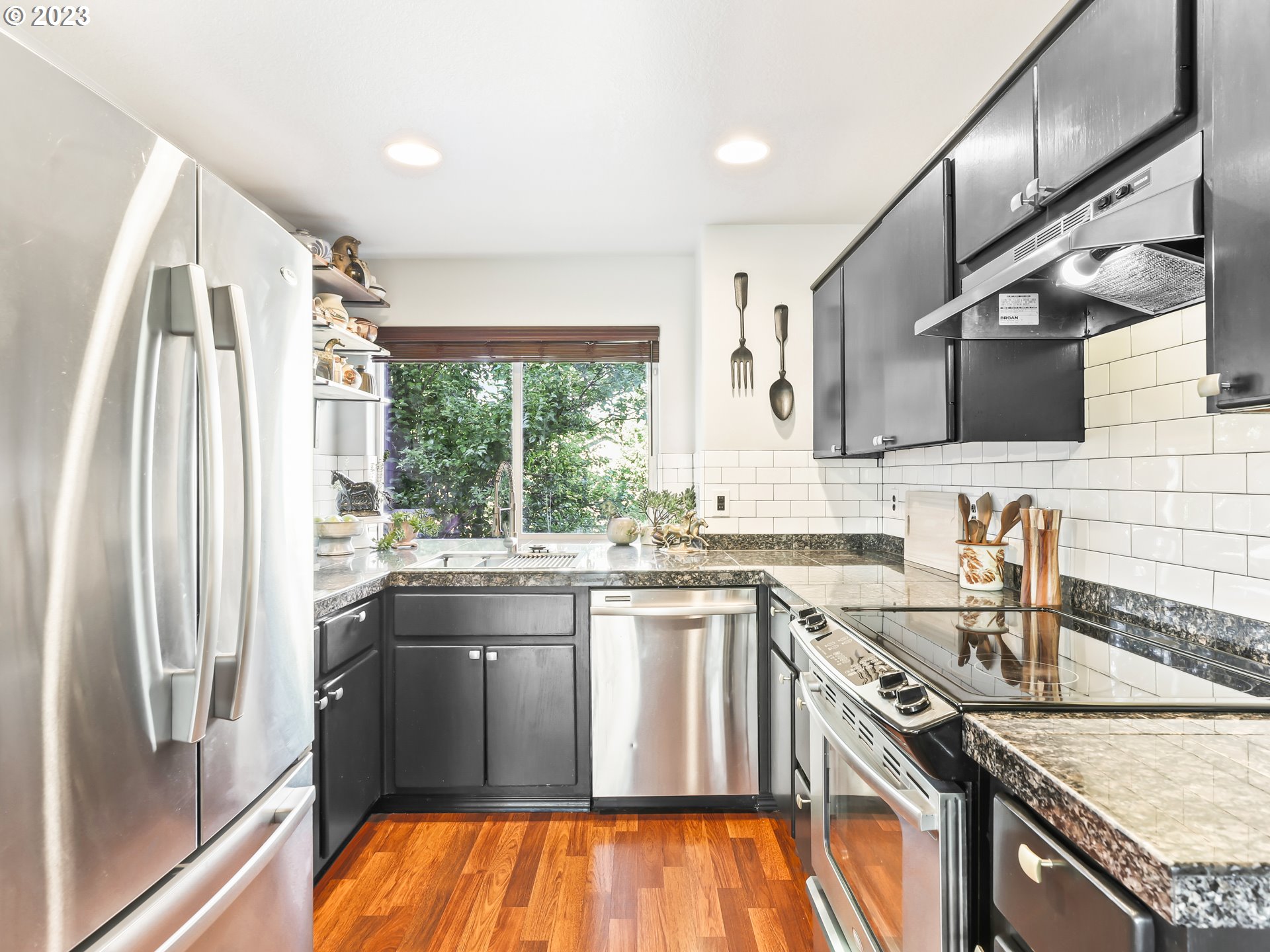 15820 Northeast Beech Street Portland, OR 97230 - Photo 9 of 28 a kitchen with stainless steel appliances granite countertop a sink stove and refrigerator