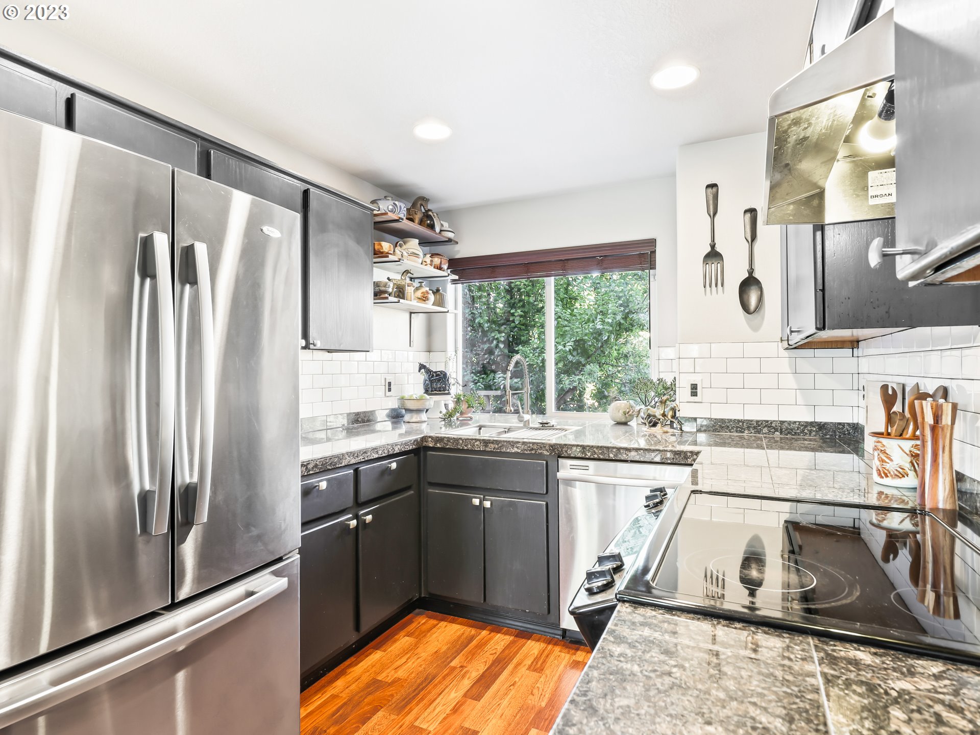 15820 Northeast Beech Street Portland, OR 97230 - Photo 10 of 28 a kitchen with stainless steel appliances granite countertop a sink stove and refrigerator